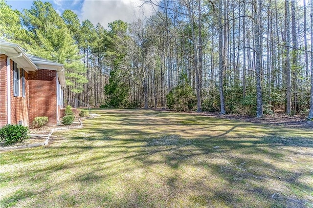 view of yard with a view of trees
