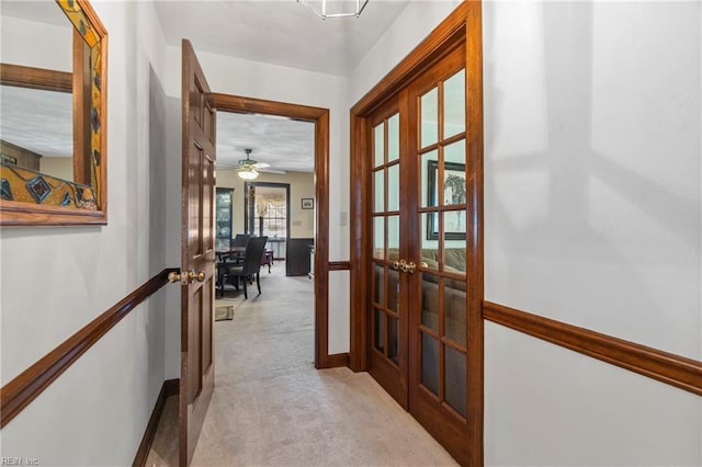 hall featuring carpet floors and french doors
