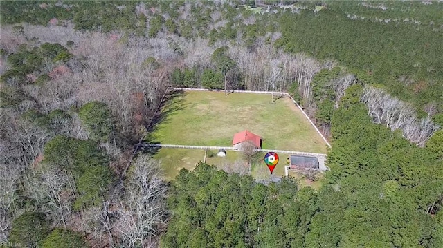 birds eye view of property with a view of trees