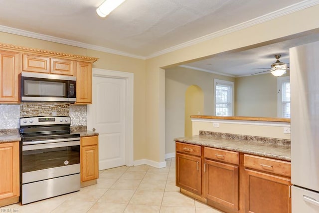 507 Bellwood Rd, Newport News, VA 23601 - kitchen featuring light tile patterned floors, arched walkways, stainless steel appliances, crown molding, and tasteful backsplash