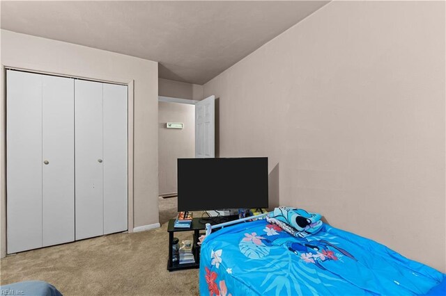 carpeted bedroom featuring a closet