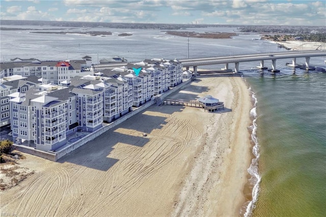 birds eye view of property with a view of the beach and a water view