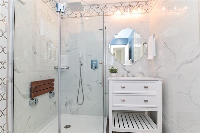 full bathroom featuring a marble finish shower and vanity