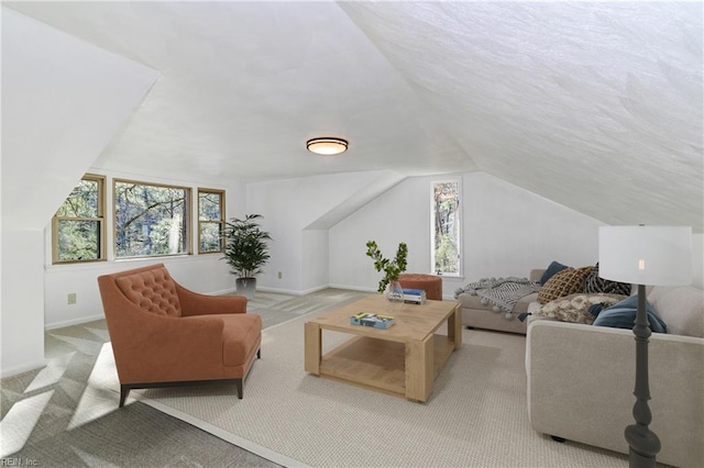 living room with light carpet, baseboards, and vaulted ceiling