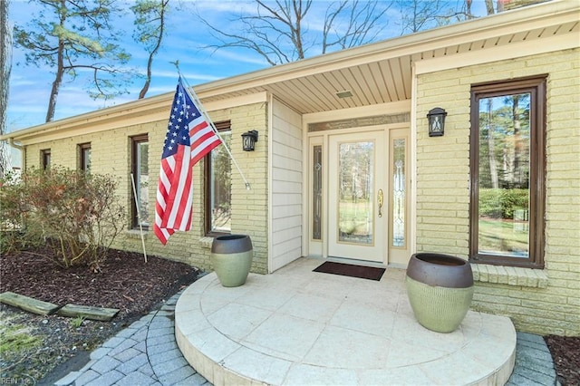 property entrance with brick siding