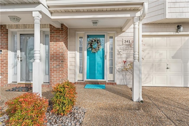 view of exterior entry with brick siding