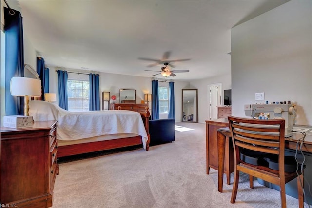 bedroom with a ceiling fan and light carpet