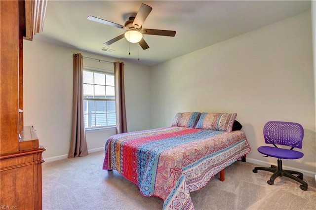 carpeted bedroom featuring visible vents, a ceiling fan, and baseboards
