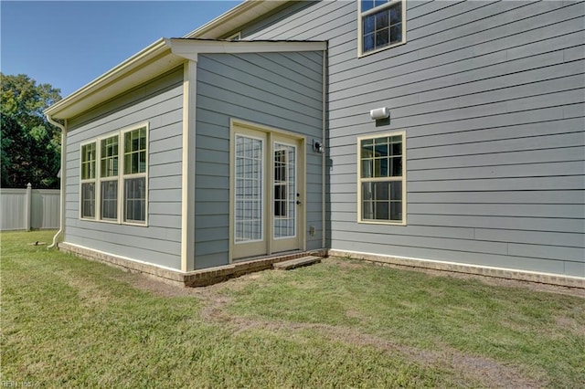 exterior space featuring a lawn and fence