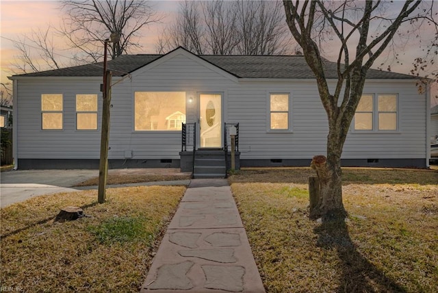 view of front of house with crawl space, a front lawn, and a shingled roof