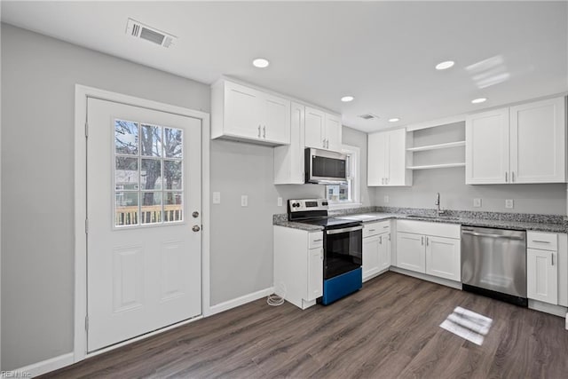 kitchen with visible vents, open shelves, dark wood-style floors, stainless steel appliances, and white cabinets