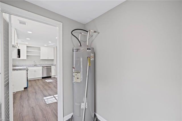 interior space with visible vents and electric water heater