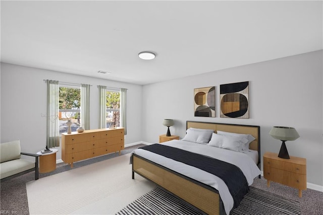 bedroom with visible vents, baseboards, and carpet