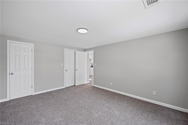 unfurnished bedroom featuring visible vents, baseboards, and carpet