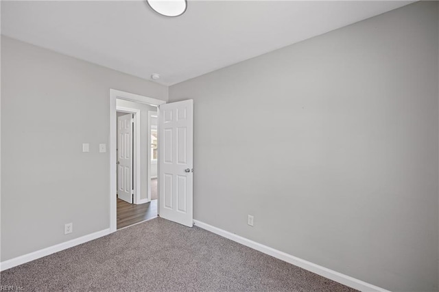 unfurnished room featuring baseboards and carpet floors