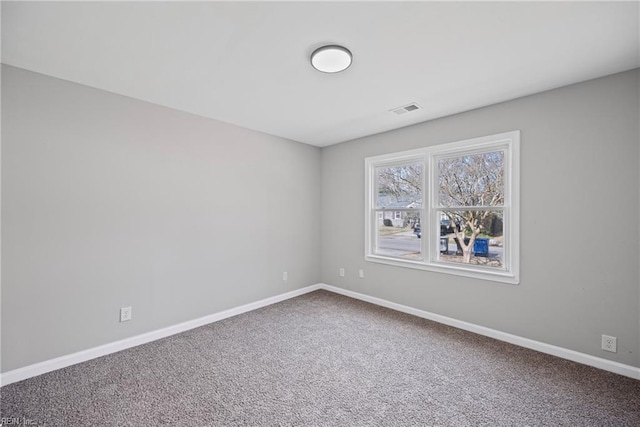 carpeted empty room with visible vents and baseboards