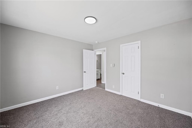 unfurnished bedroom with carpet flooring and baseboards