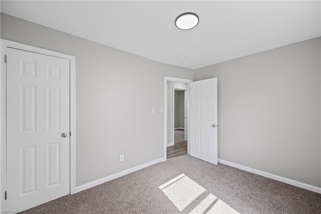 unfurnished bedroom featuring baseboards and carpet floors