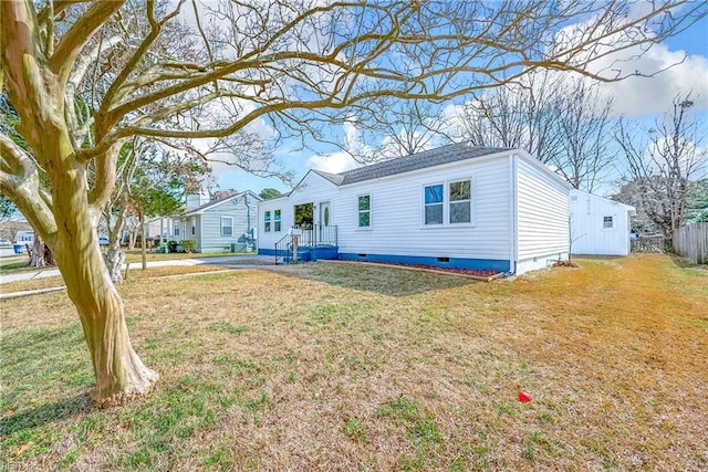 view of front of house with a front lawn, fence, and crawl space