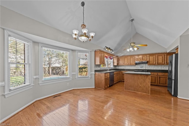 4825 Berrywood Rd, Virginia Beach, VA 23464 - kitchen featuring under cabinet range hood, dark countertops, appliances with stainless steel finishes, and a healthy amount of sunlight