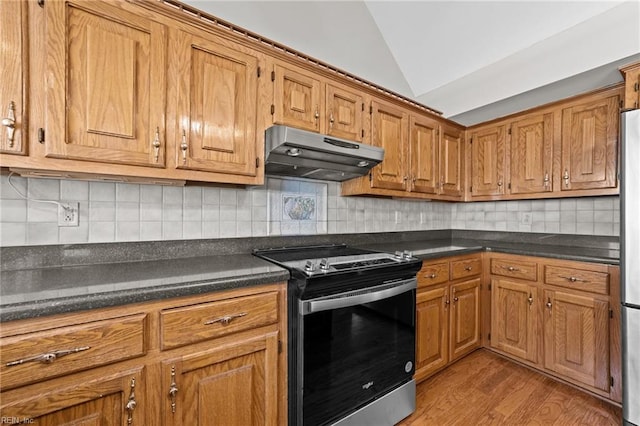 4825 Berrywood Rd, Virginia Beach, VA 23464 - kitchen featuring under cabinet range hood, lofted ceiling, dark countertops, and range with electric stovetop