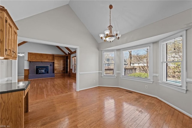 4825 Berrywood Rd, Virginia Beach, VA 23464 - unfurnished dining area with an inviting chandelier, wood-type flooring, a fireplace, visible vents, and baseboards