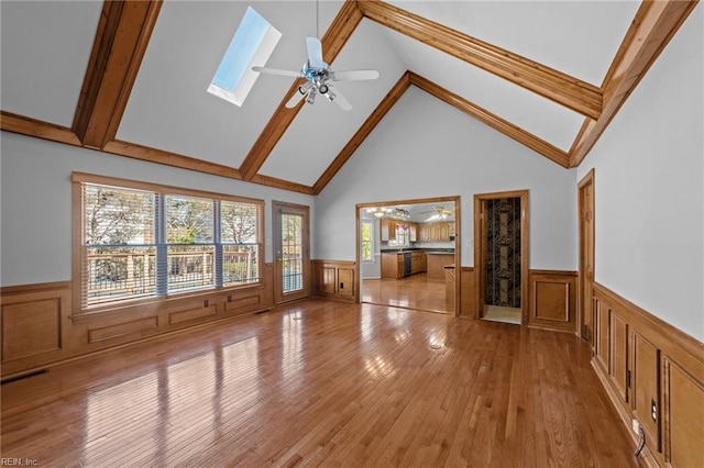 4825 Berrywood Rd, Virginia Beach, VA 23464 - unfurnished living room with beamed ceiling, a wainscoted wall, a ceiling fan, and light wood-style floors