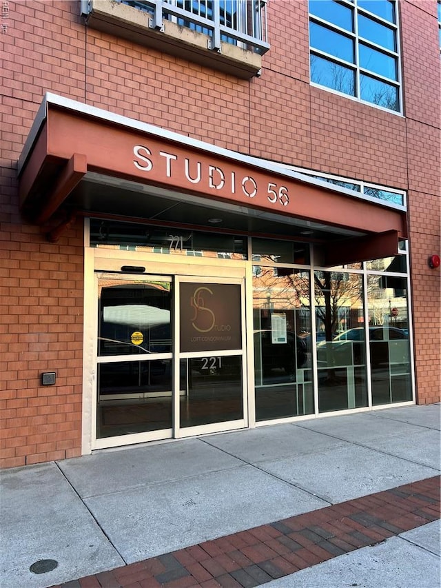property entrance with brick siding