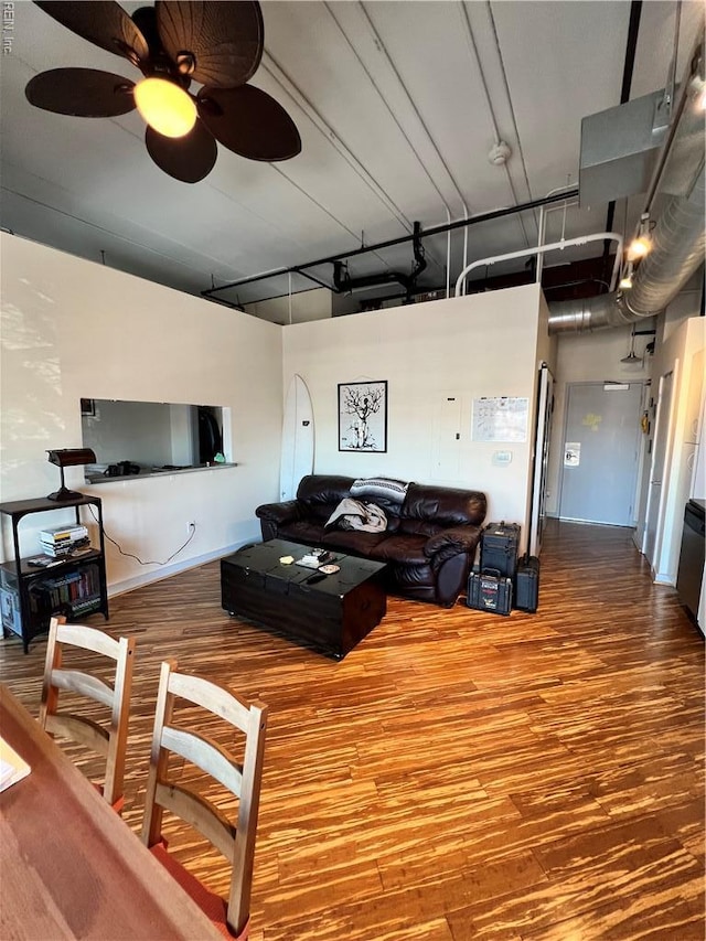 living area with wood finished floors and a ceiling fan