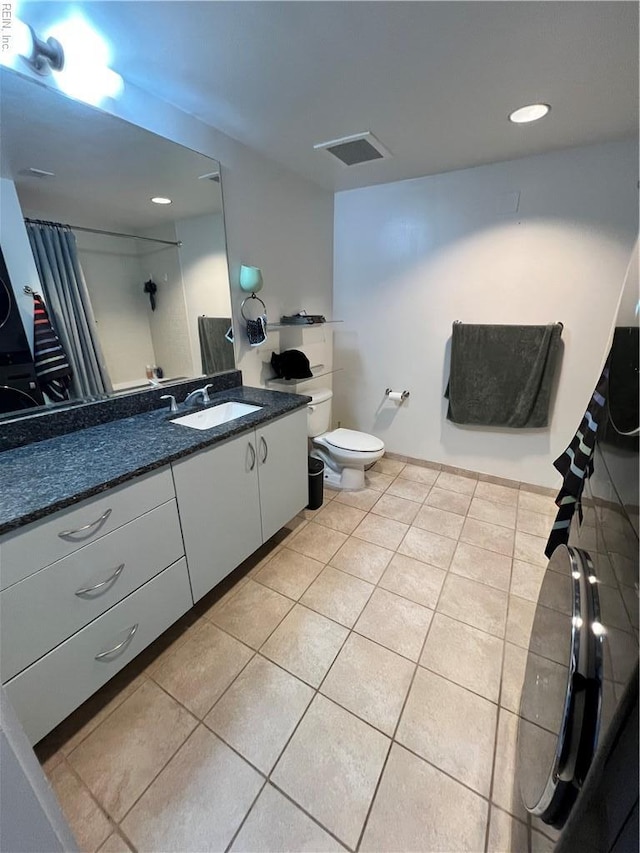 full bathroom with visible vents, toilet, tile patterned floors, curtained shower, and vanity