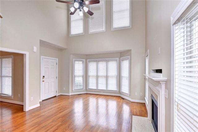 296 Walt Whitman Ave, Newport News, VA 23606 - unfurnished living room featuring light wood finished floors, a fireplace with flush hearth, baseboards, and a ceiling fan