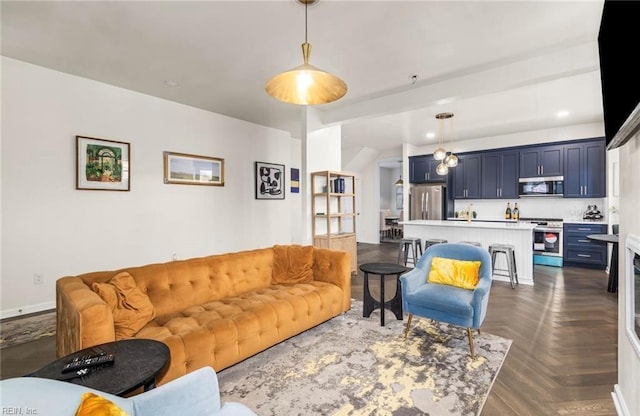 living area featuring baseboards and recessed lighting