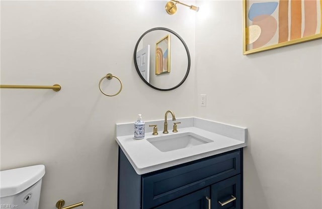 bathroom with toilet and vanity