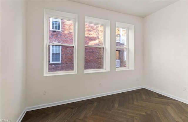 unfurnished room with baseboards