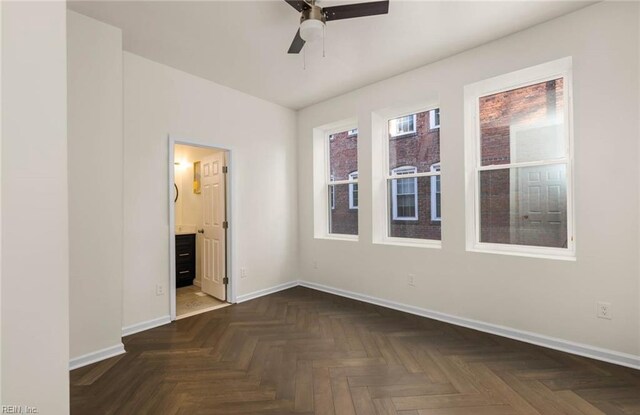 empty room with baseboards and a ceiling fan