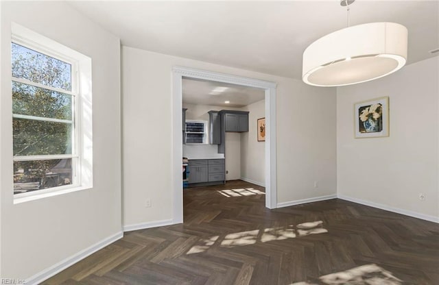 interior space with baseboards and an AC wall unit