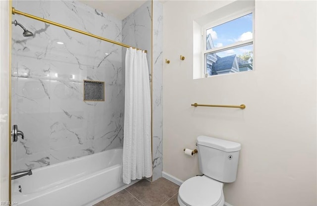 full bath featuring tile patterned floors, shower / tub combo, toilet, and baseboards