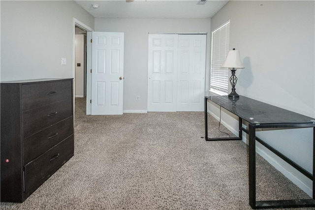 unfurnished bedroom featuring carpet flooring, a closet, and baseboards