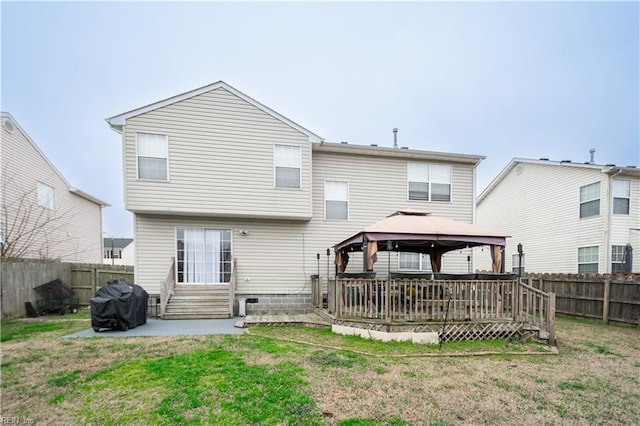 back of property featuring a fenced backyard, a gazebo, and a yard