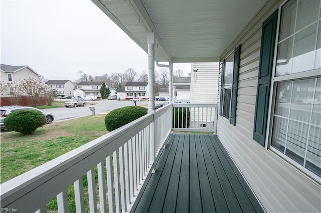 wooden terrace with covered porch and a residential view