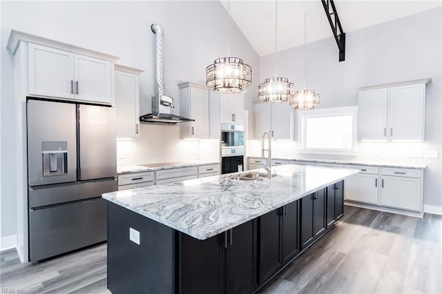 11AC Glass Rd, Hayes, VA 23072 - kitchen featuring high vaulted ceiling, a center island with sink, stainless steel refrigerator with ice dispenser, an inviting chandelier, and wall chimney exhaust hood