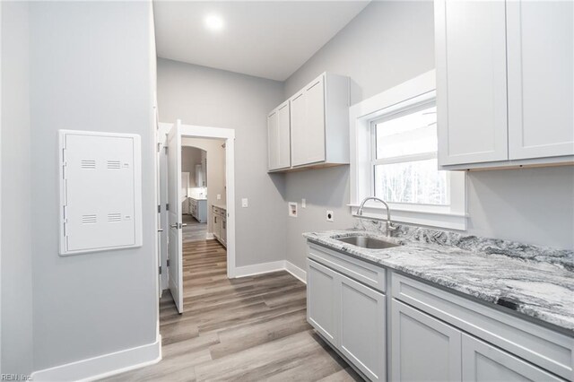 11AC Glass Rd, Hayes, VA 23072 - kitchen featuring light stone counters, light wood-style floors, baseboards, and a sink