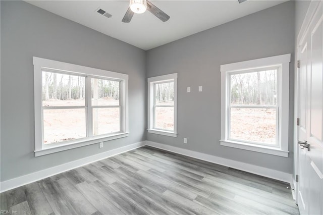11AC Glass Rd, Hayes, VA 23072 - spare room with wood finished floors, a ceiling fan, visible vents, and baseboards