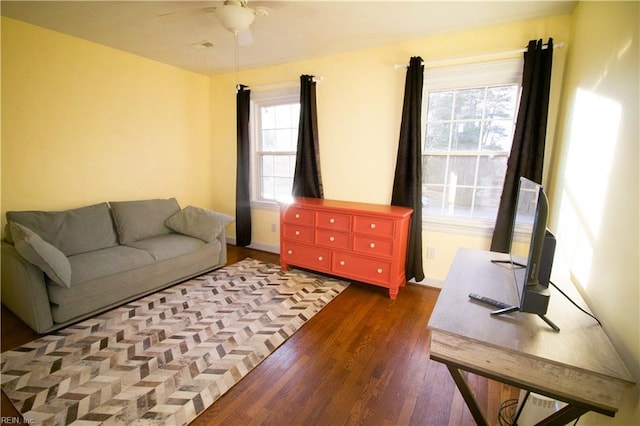 living area featuring wood finished floors and a ceiling fan
