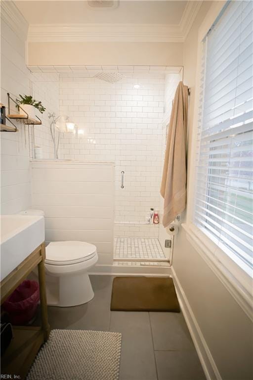 bathroom with tile patterned floors, toilet, vanity, a shower stall, and ornamental molding