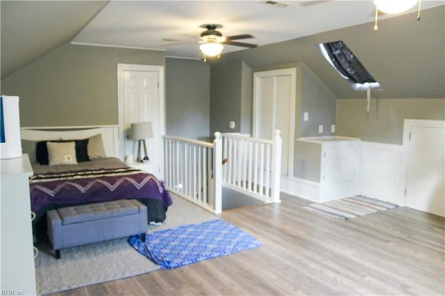 bedroom with lofted ceiling, wood finished floors, and a ceiling fan