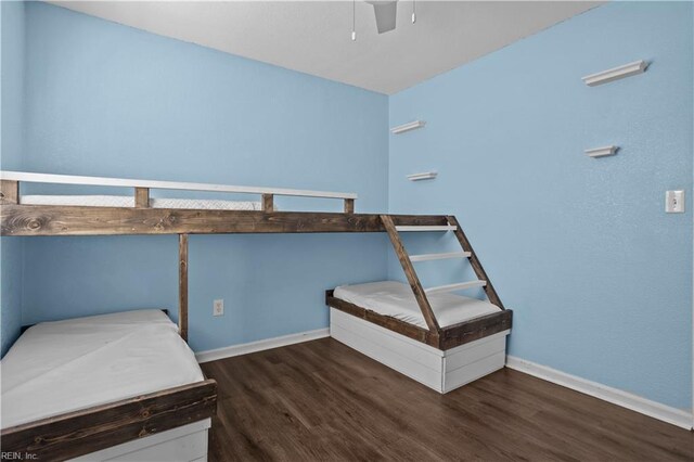 bedroom with baseboards, wood finished floors, and a ceiling fan