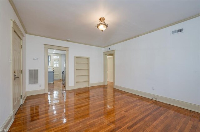 911 Spotswood Ave Unit 6, Norfolk, VA 23517 - empty room featuring wood finished floors, ornamental molding, baseboards, and built in shelves