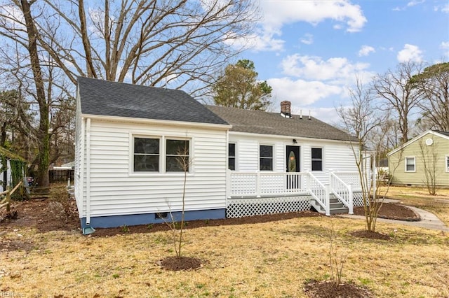 view of front of home with a chimney, crawl space, a shingled roof, and a front lawn
