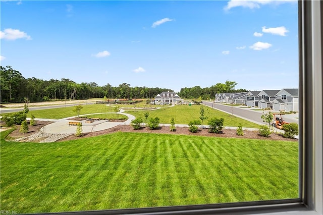 surrounding community with a lawn and a residential view